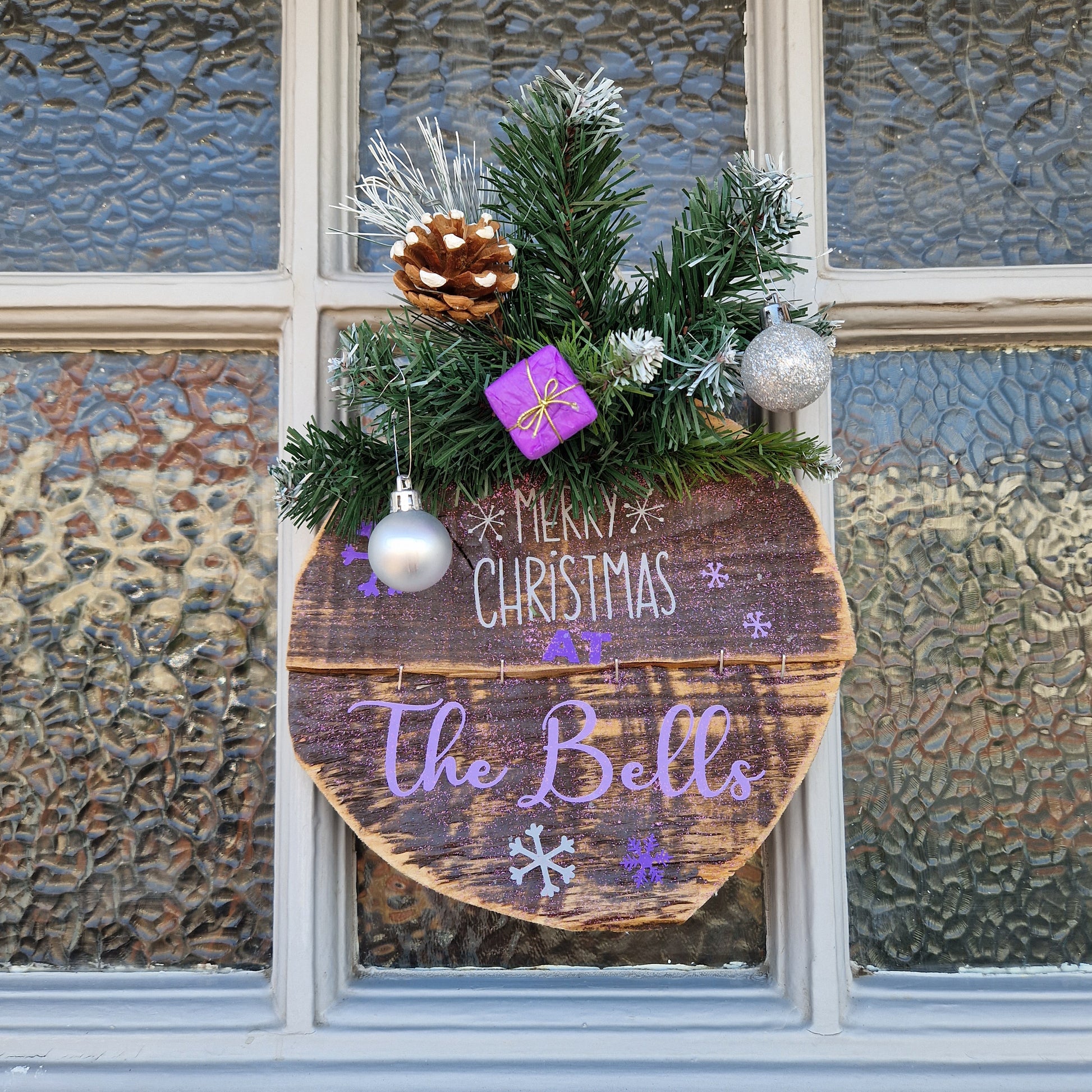 Merry Christmas at rustic wooden sign in purple